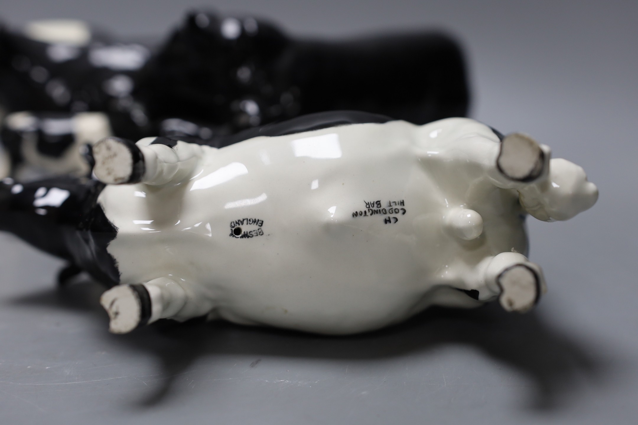 A Beswick Aberdeen Angus bull, cow and calf, together with a Godington Hilt Bar bull, cow and calf